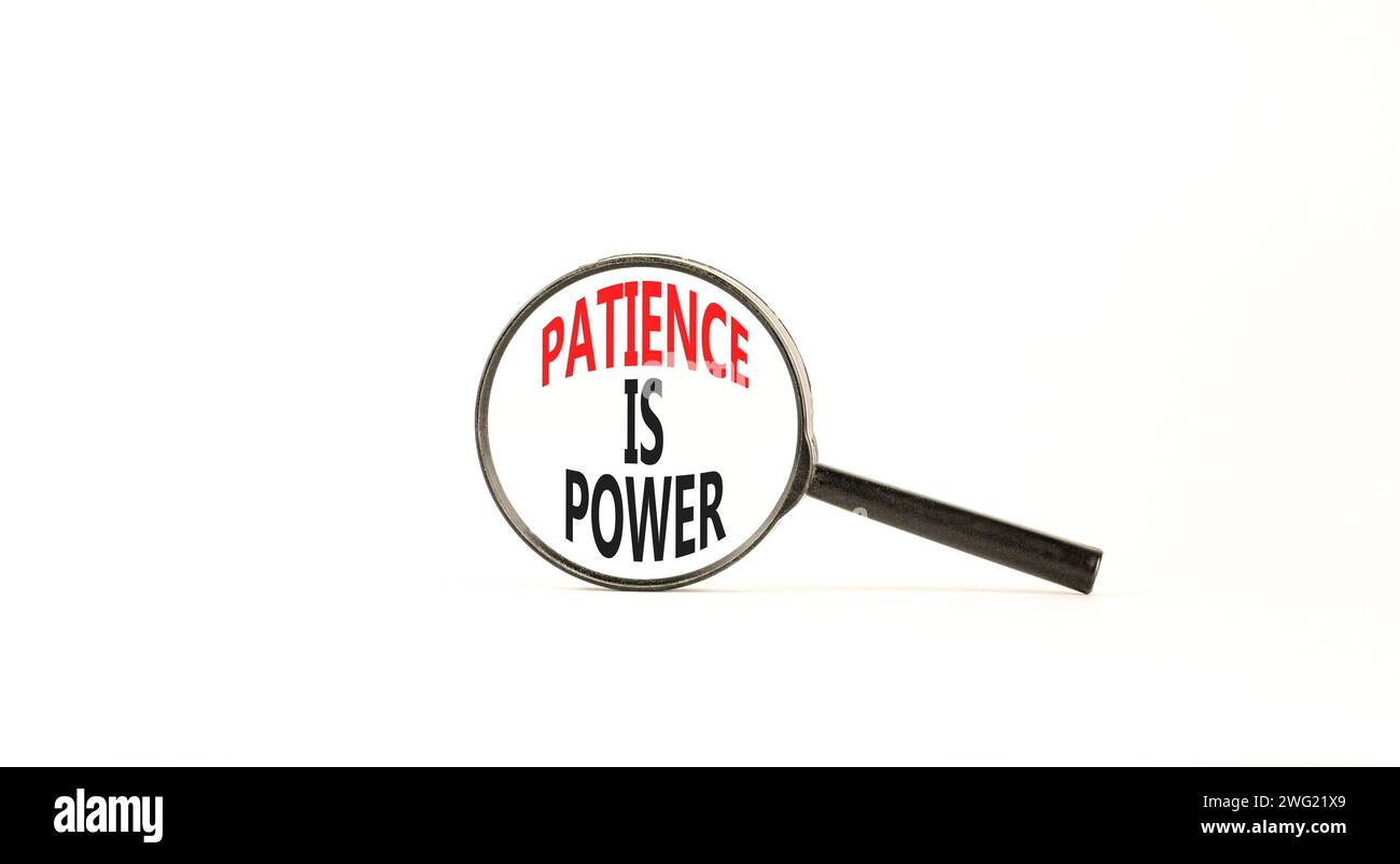 Patience is power symbol. Concept words Patience is power in beautiful magnifying glass. Beautiful white table white background. Business and patience Stock Photo