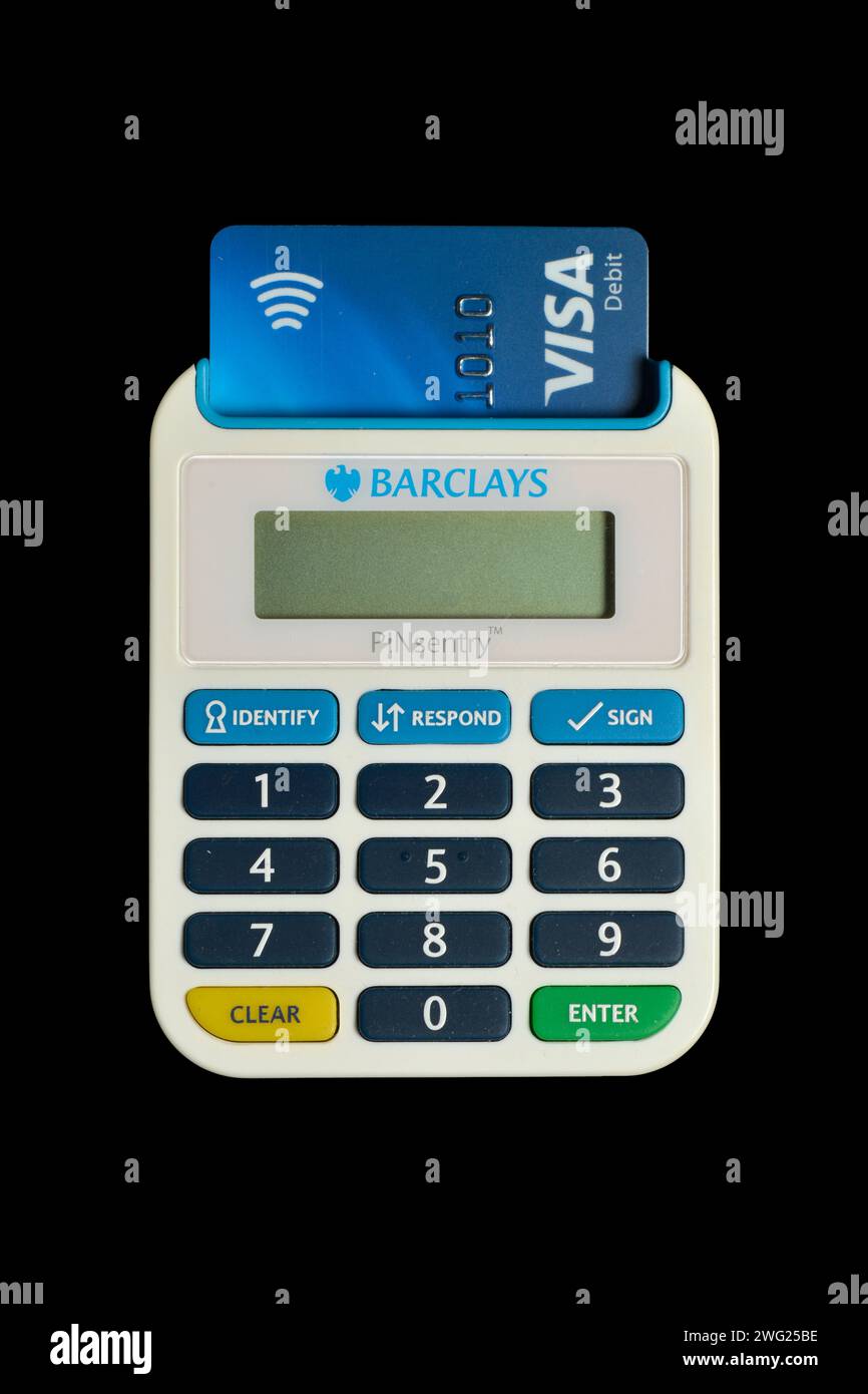 Barclays Pinsentry card reader device and Visa debit card isolated on black Stock Photo