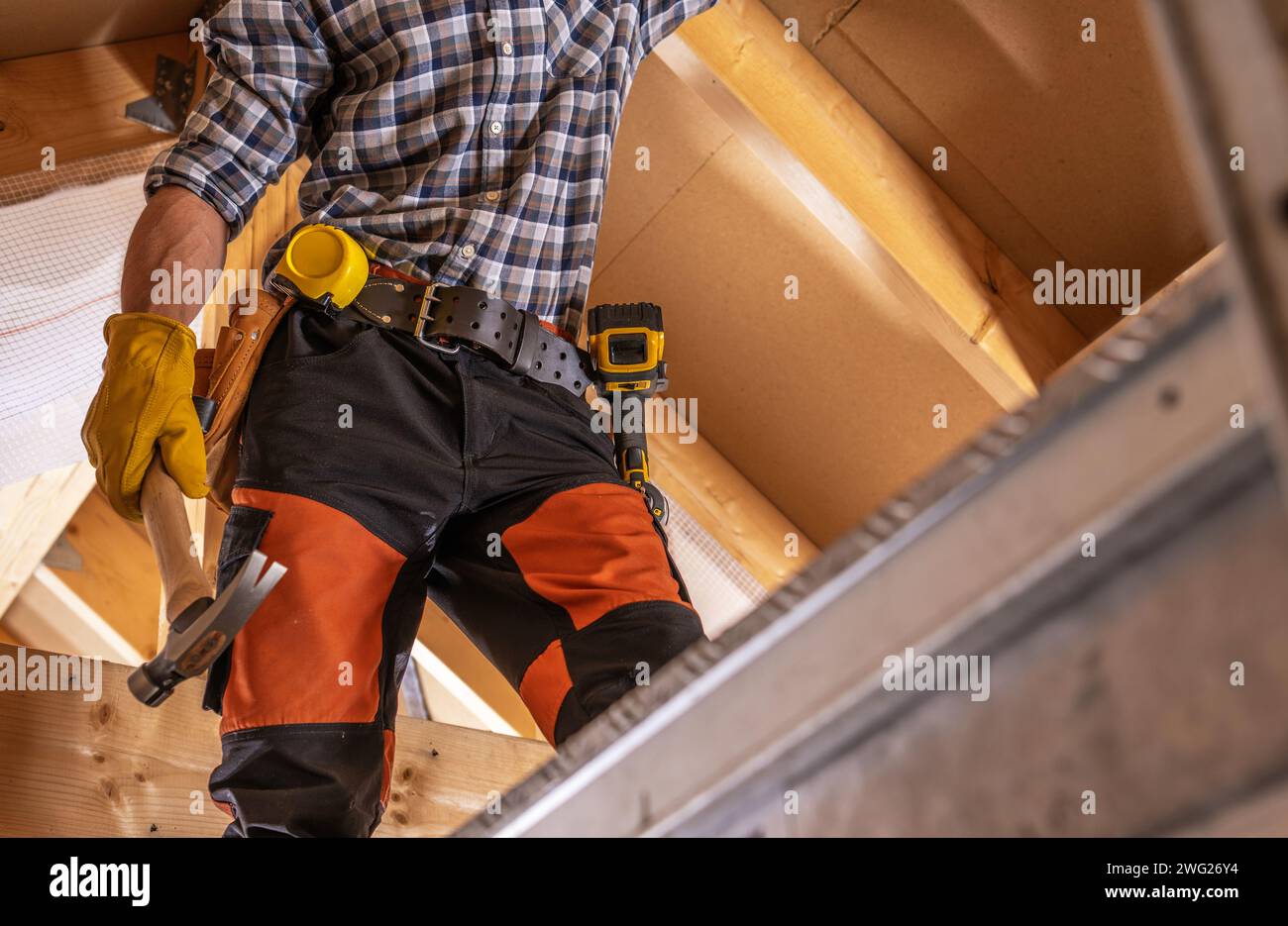 Construction Site Theme. Worker on a Scaffolding Close Up Stock Photo