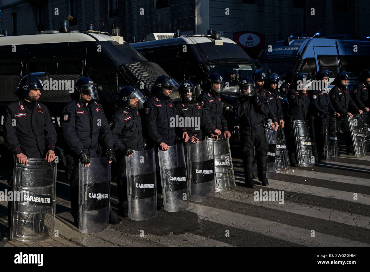 Milan, Italy - January 27, 2024: Carabinieri officers in full riot gear stand in formation to cordon off an area during a demo Stock Photo