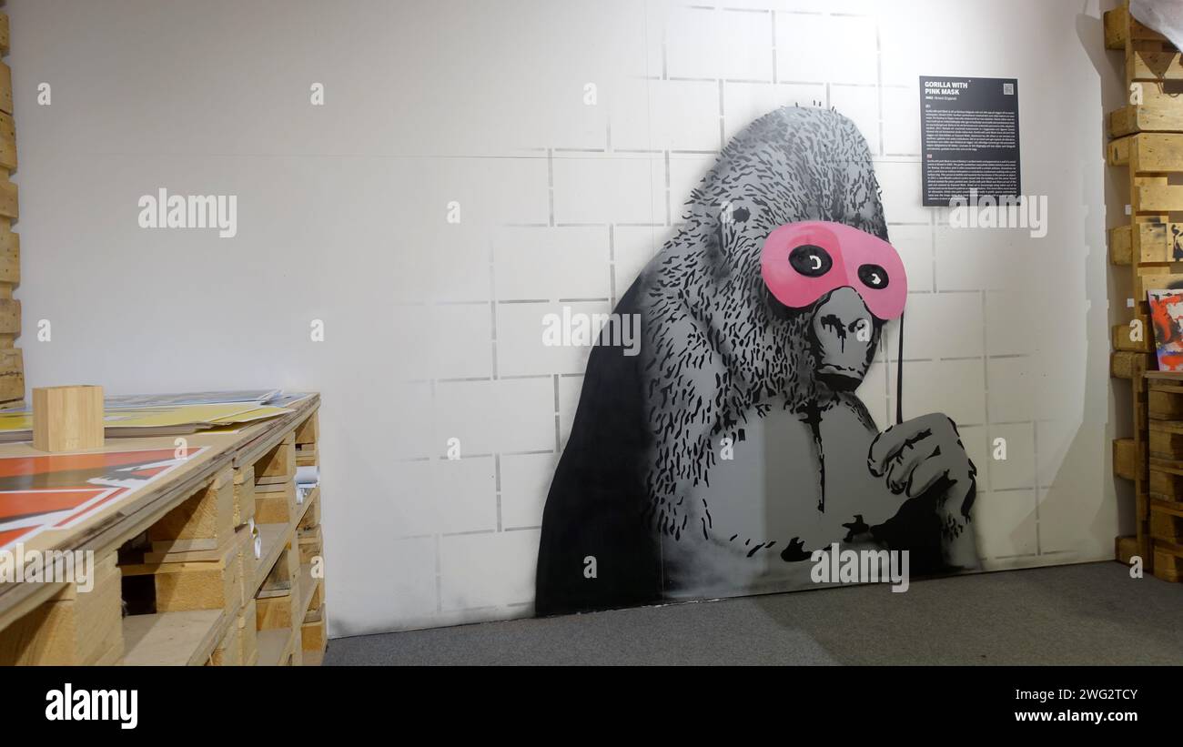 Banksy gorilla painting wall hi-res stock photography and