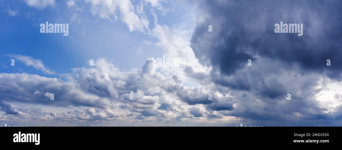 Beautiful blue sky panorama with dark clouds at daylight. Stock Photo