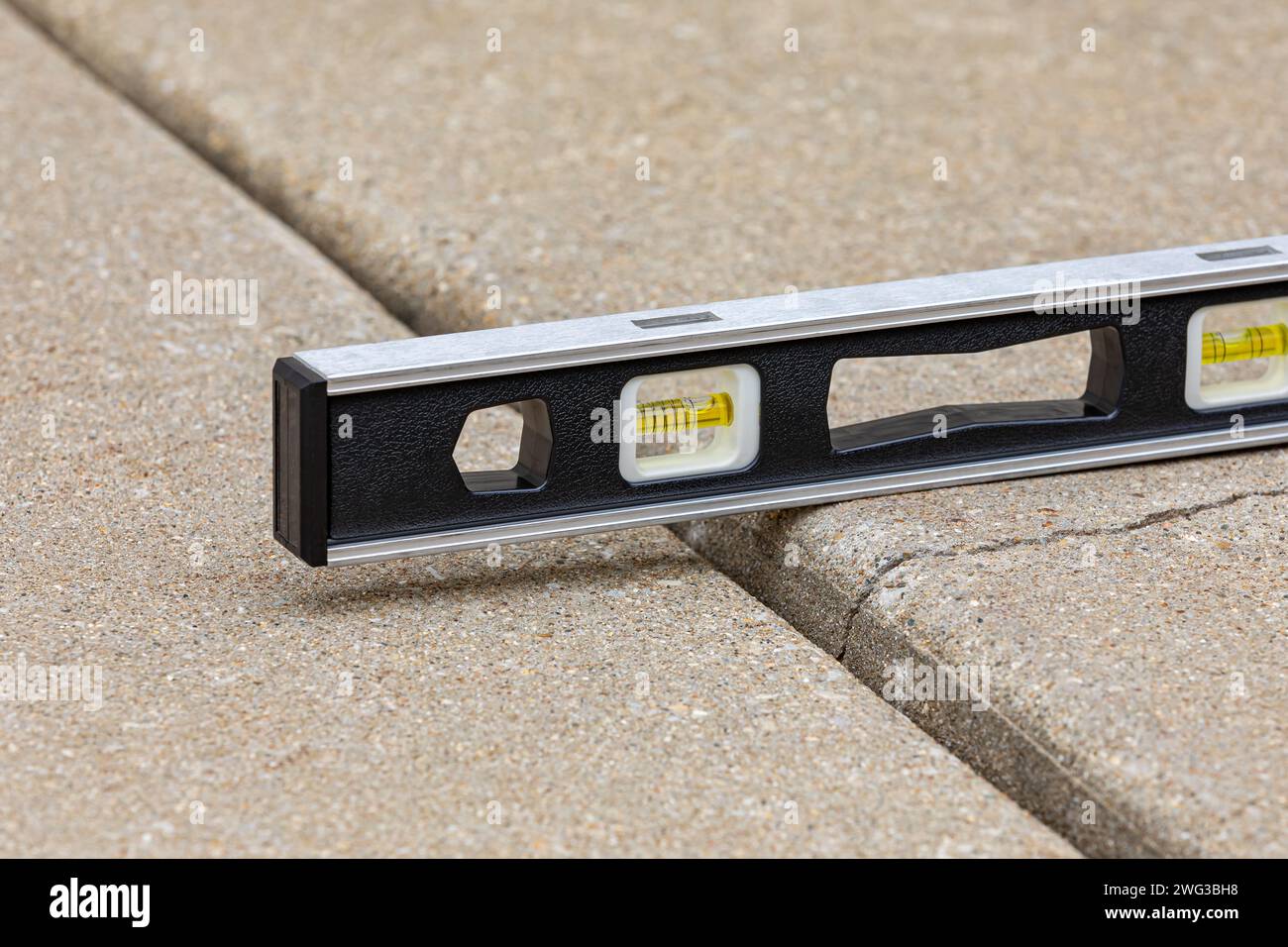 Concrete driveway cracked and settling. Home inspection, slab jacking