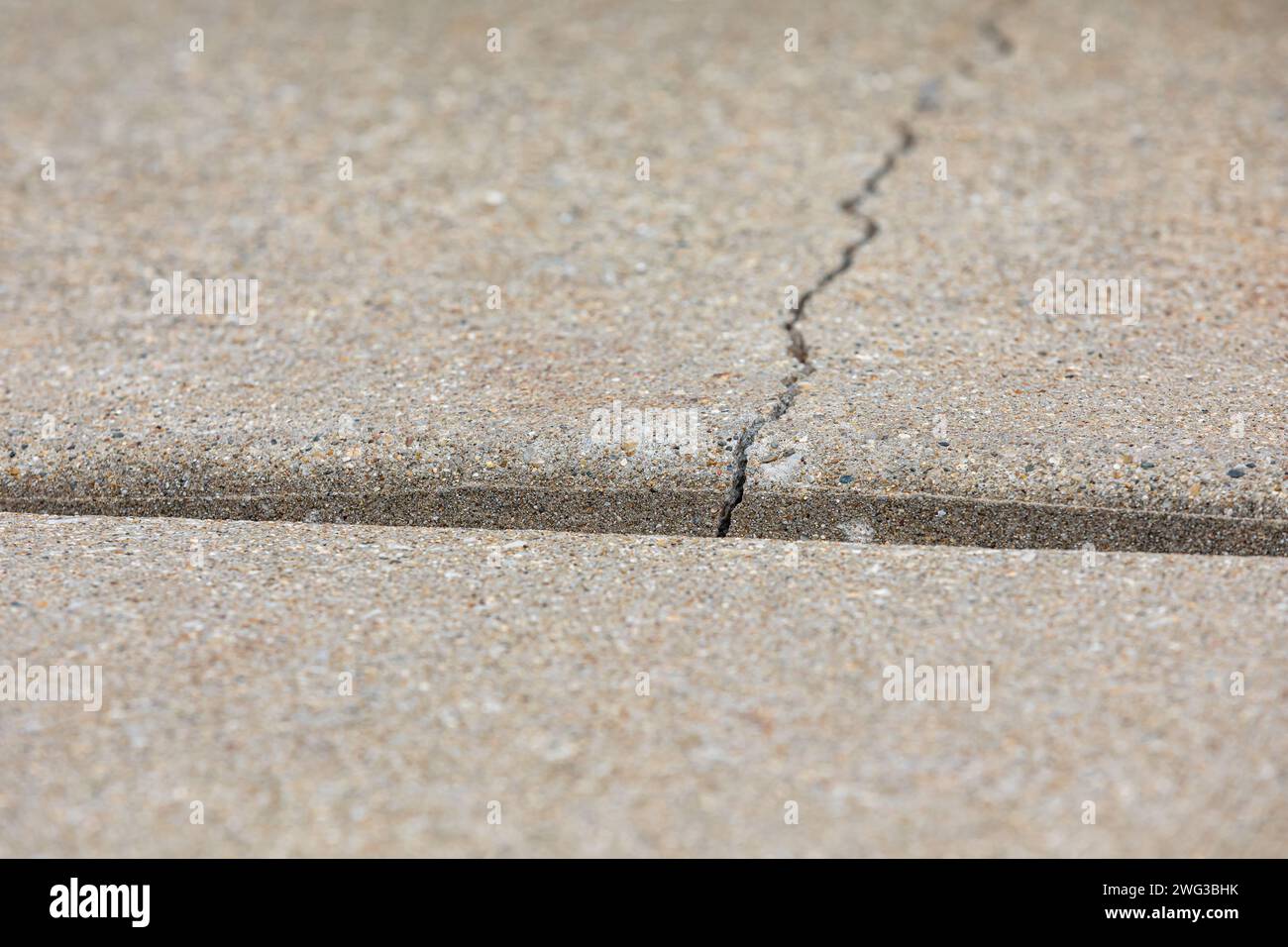 Concrete driveway cracked and settling. Home inspection, slab jacking