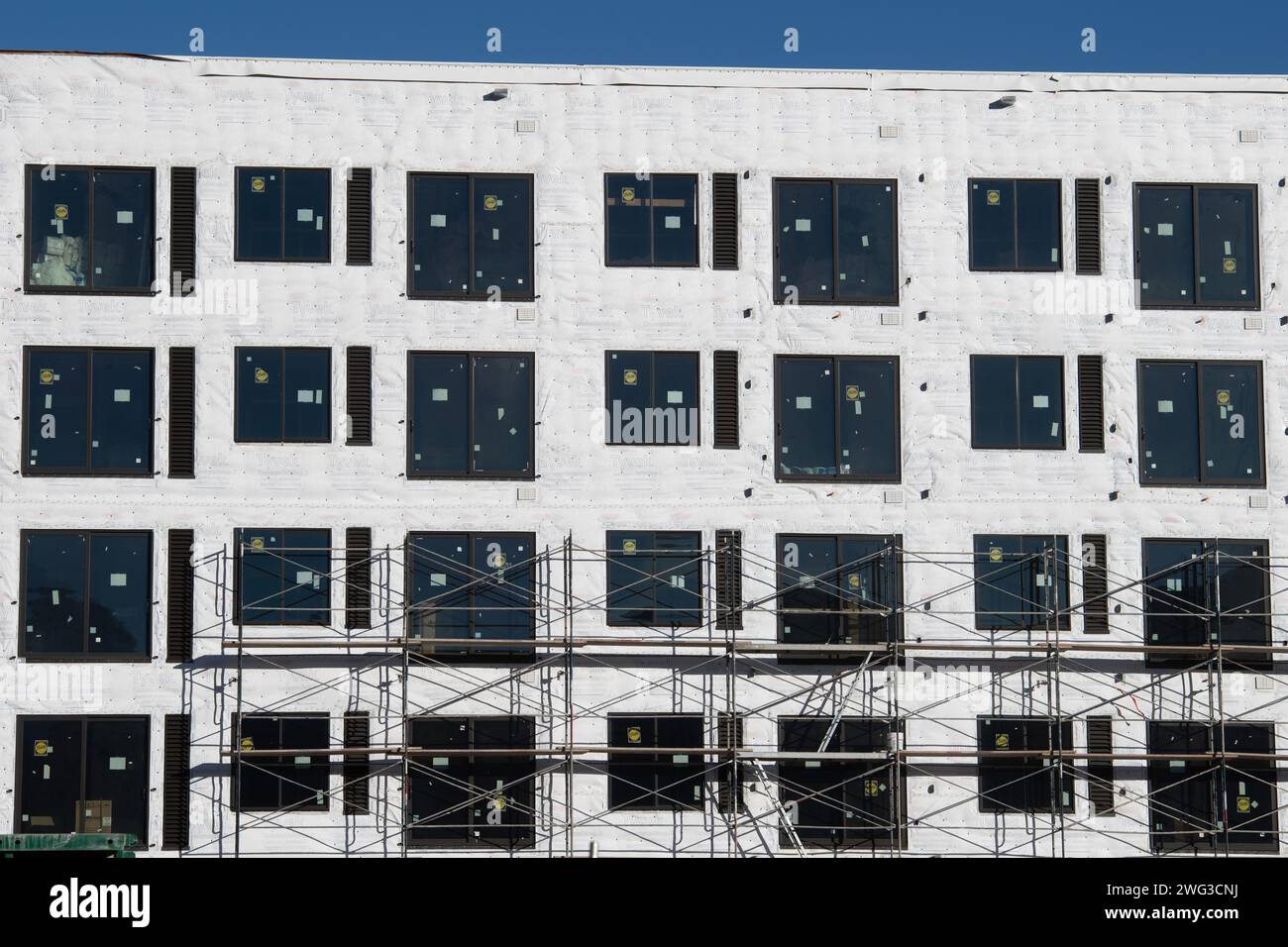 Energy efficient apartment building under construction, Downtown Colorado Springs, Colorado.  Tyvec moisture barriers and insulation, Pella Windows Stock Photo