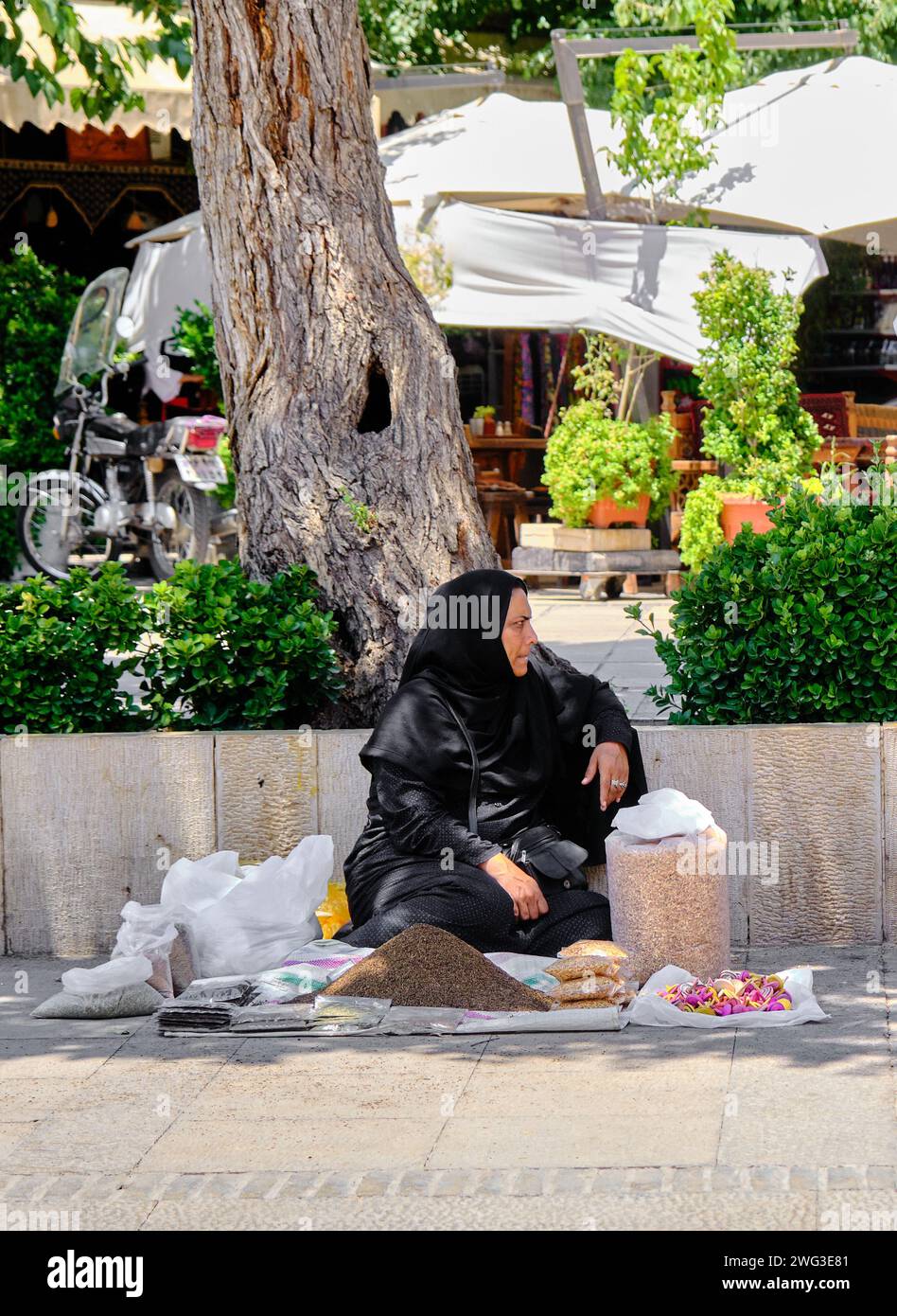 Shiraz, Iran 06.26.2023: an old iranian women, sells local food. Stock Photo