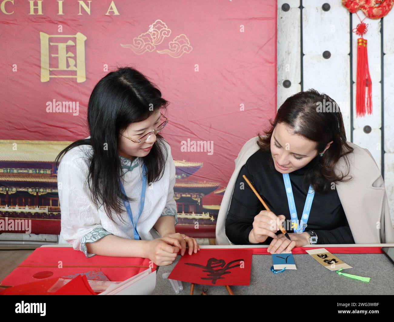 Geneva, Switzerland. 2nd Feb, 2024. A guest (R) learns to write the Chinese characters during an event to celebrate the upcoming Spring Festival in Geneva, Switzerland, Feb. 2, 2024. The United Nations (UN) Office in Geneva celebrated the upcoming Spring Festival on Friday, gathering about 300 diplomats and representatives from 51 countries and 15 international organizations. TO GO WITH 'Roundup: UN diplomats celebrate Spring Festival in Geneva' Credit: Wang Qibing/Xinhua/Alamy Live News Stock Photo