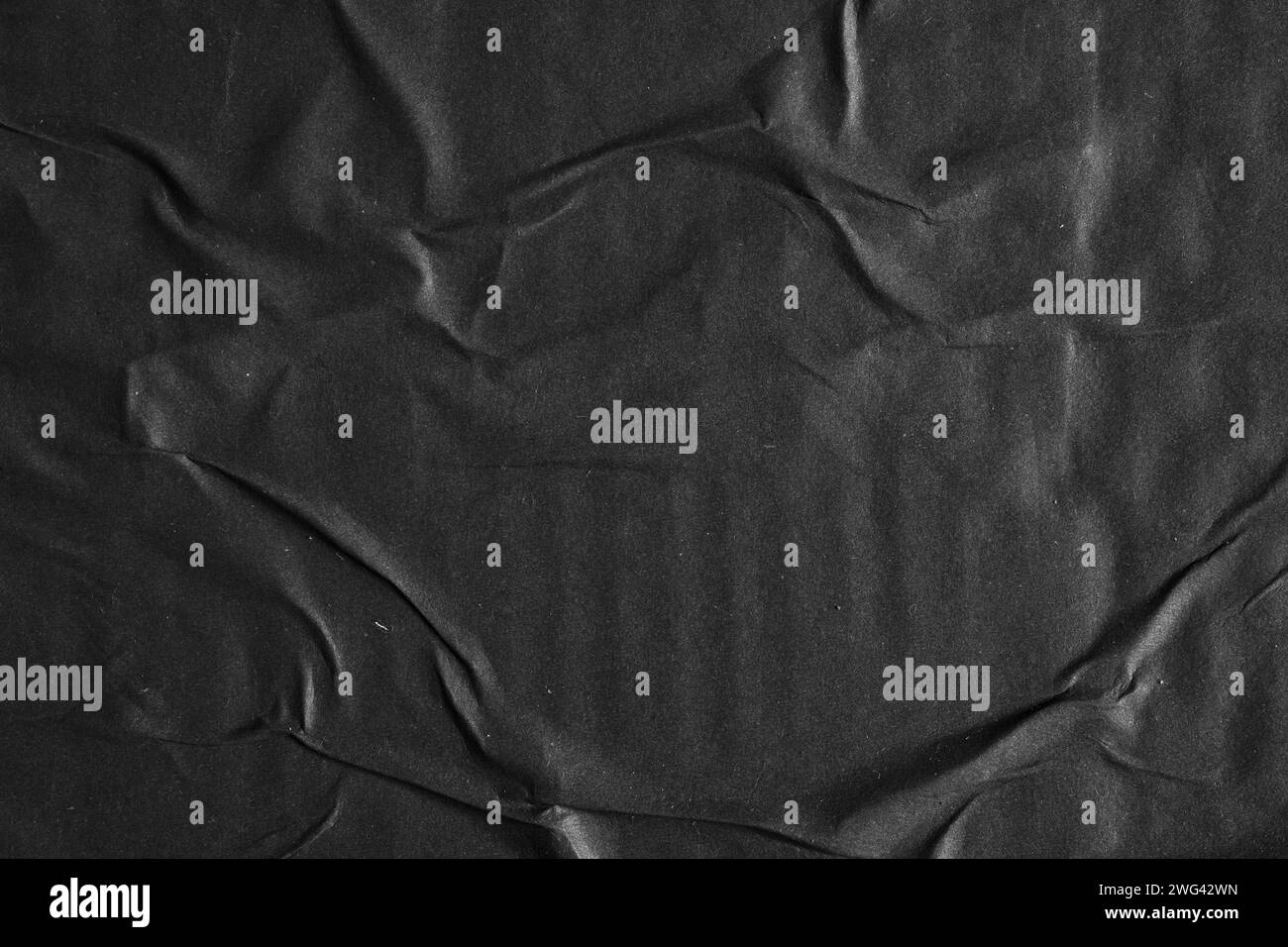Black paper poster glued on a wall texture background Stock Photo