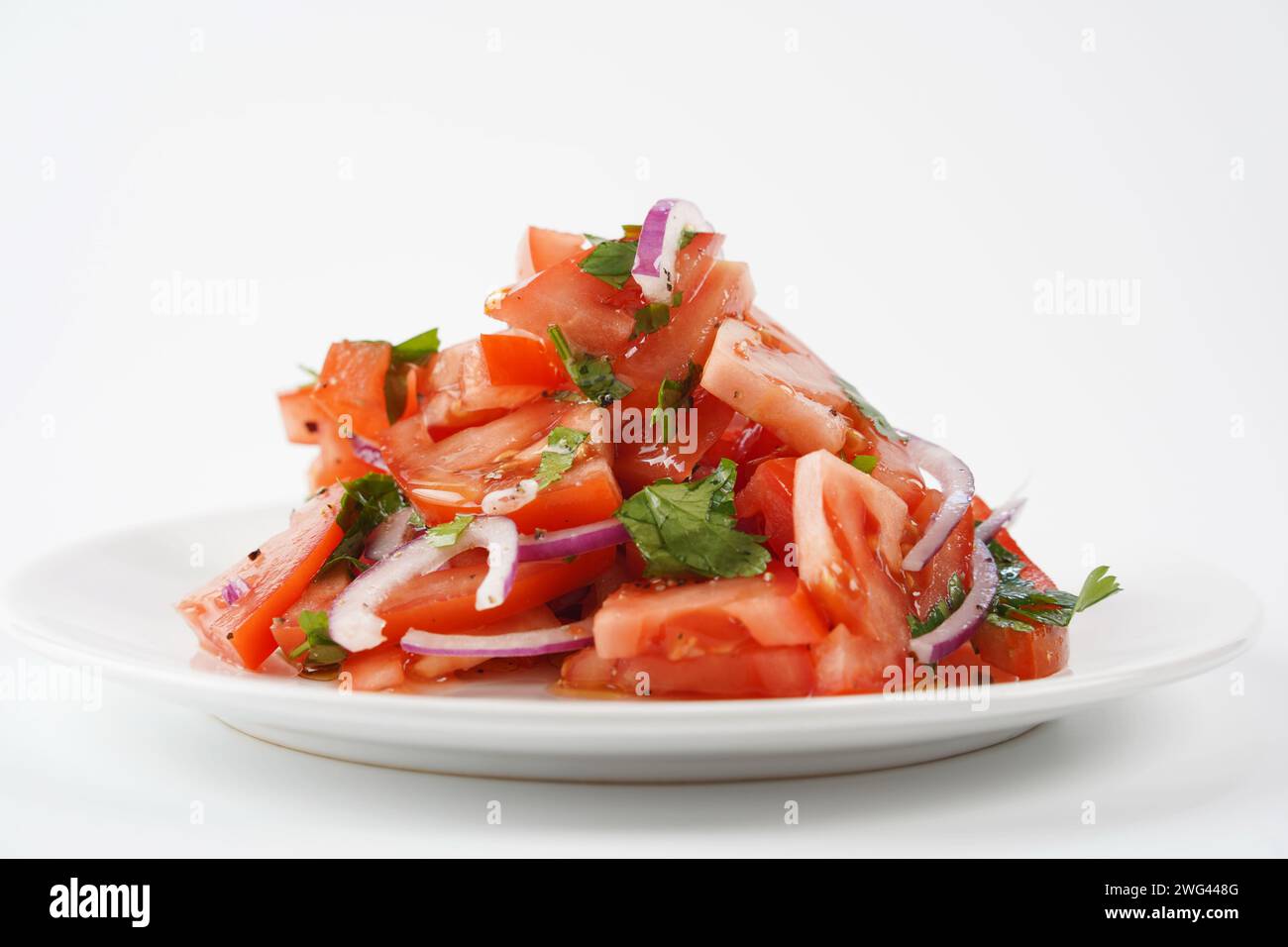 Salad with fresh tomatoes, olive oil, onions, parsley and fennel. Stock Photo