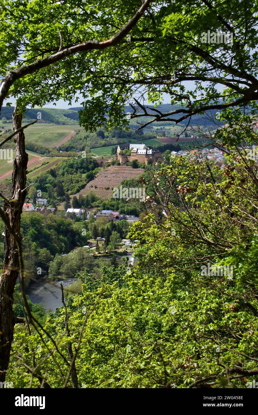 Bad Munster, Germany - May 12, 2021: Rheingrafenstein Castle through trees with green leaves on a spring day in Rhineland Palatinate, Germany. Stock Photo