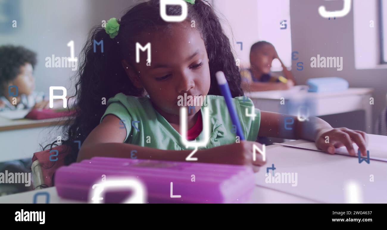 Image of letters and numbers over biracial schoolgirl concentrating writing at desk in class Stock Photo
