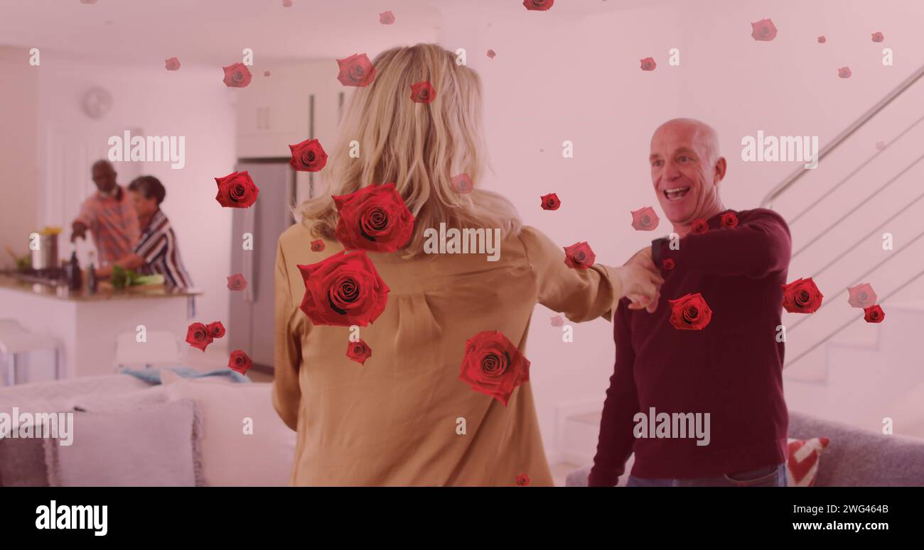 Image of rose icons over diverse group of seniors dancing and cooking Stock Photo