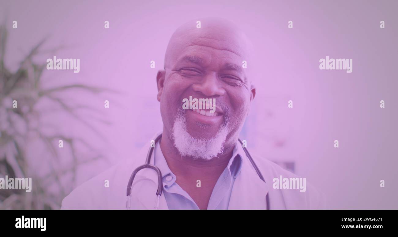 Senior African American doctor smiles warmly, with copy space Stock Photo
