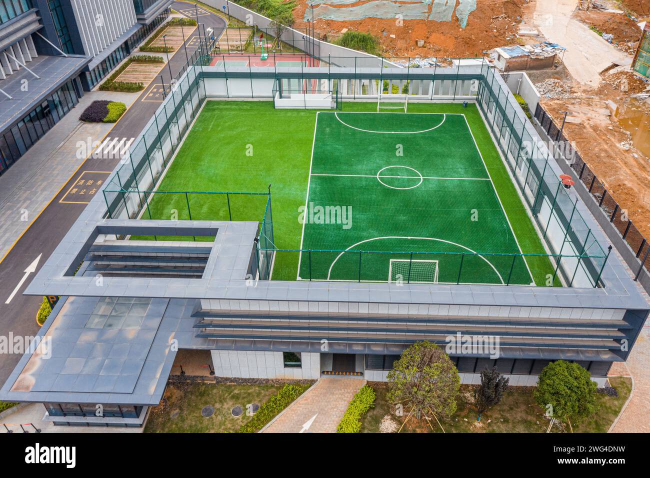 An aerial view of a football field on a rooftop next to a hightech