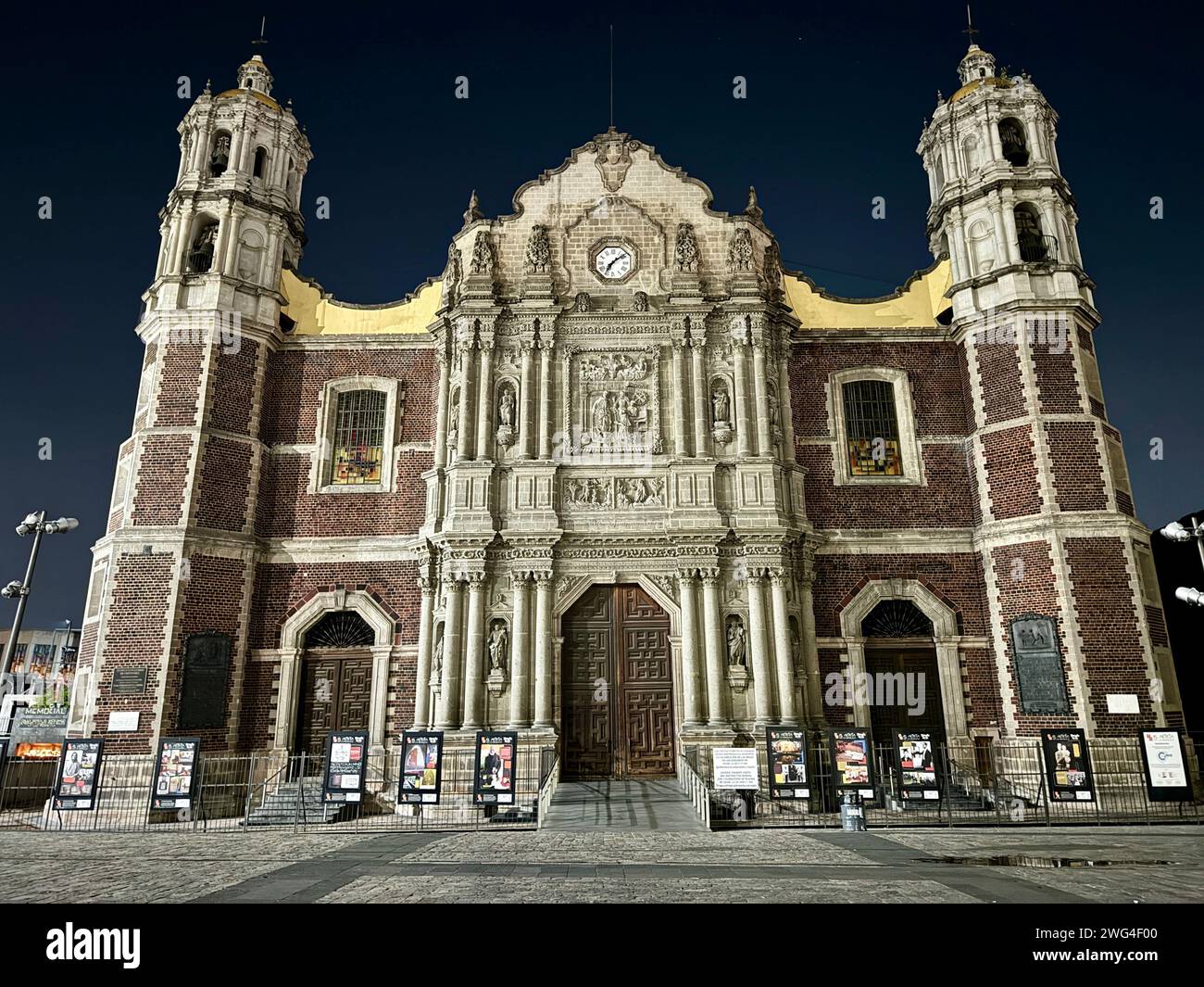 Brick building showcasing a prominent clock on its facade Stock Photo