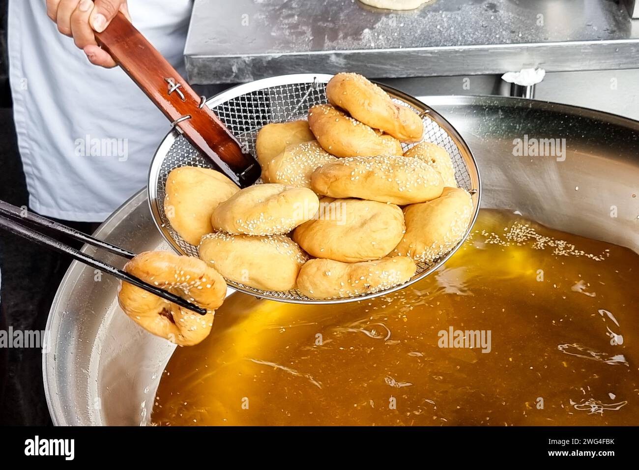 Hawker scooping out cooked Ham Chim Peng from wok, a popular Chinese street food in Malaysia Stock Photo