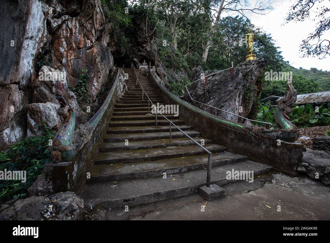 Entrance to one of the caves at the Wat Tham Pla Temple. Wat Tham Pla ...