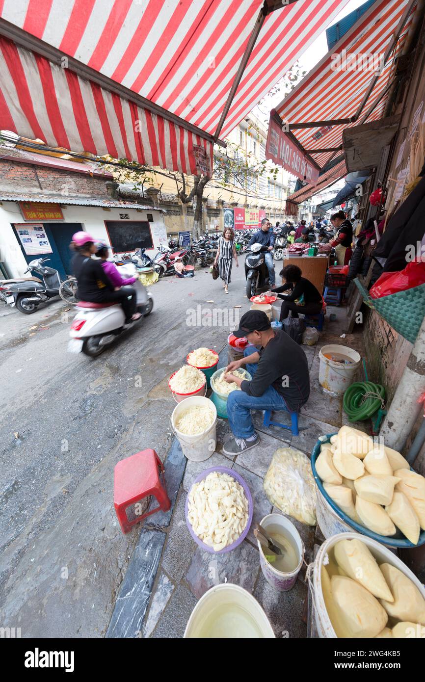 Vietnam, Hanoi, street vendor making a type of bread. Stock Photo