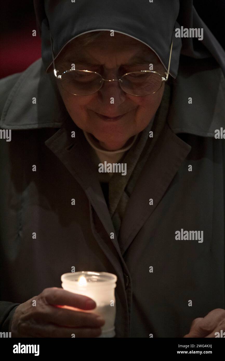 Vatican City, Vatican, 2 february, 2024. Nun holds a candles during the