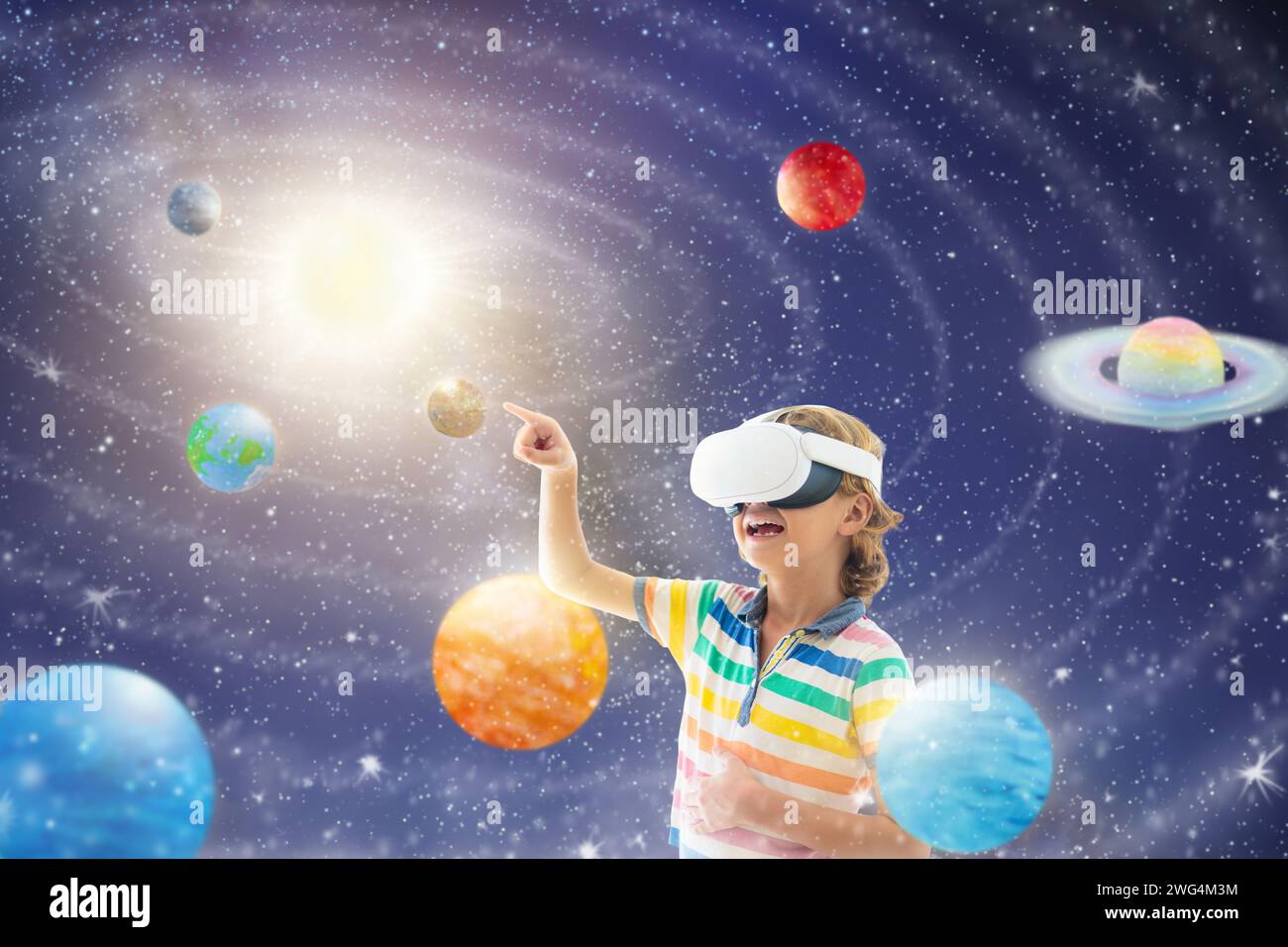 Child in virtual reality goggles looking at solar system model. Kid exploring space and universe in VR set. Modern study device. Stock Photo