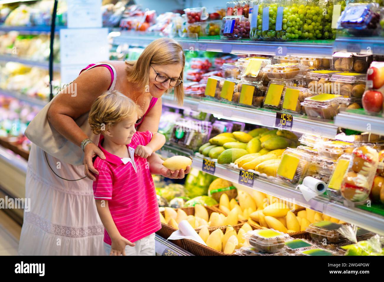 Shopping with kids. Mother and child buying fruit in supermarket. Mom