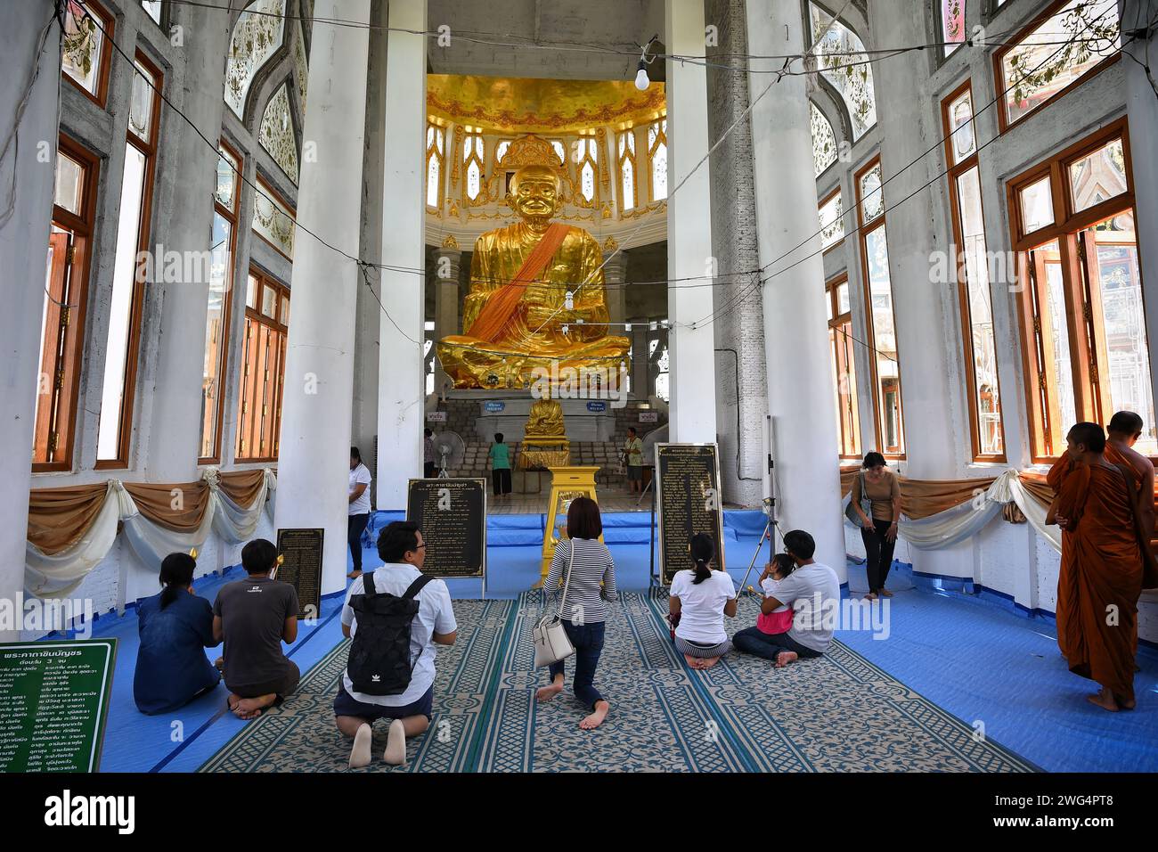 Sikhio, Thailand - Jun 4, 2019: Pilgrims and prayers are paying respect to the highly famous monk statue cover by gold and have a name 'Somdet Phra Bu Stock Photo
