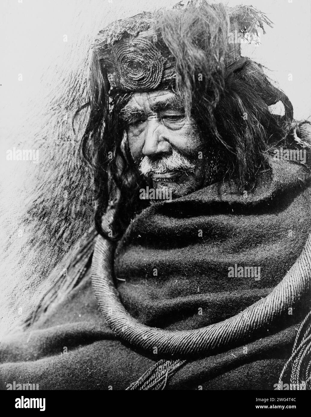 The Hamatsa-Nakoaktok, 1910, c1910. Half-length portrait of Nakoaktok man, facing left, wearing cedar root ceremonial loop. Stock Photo