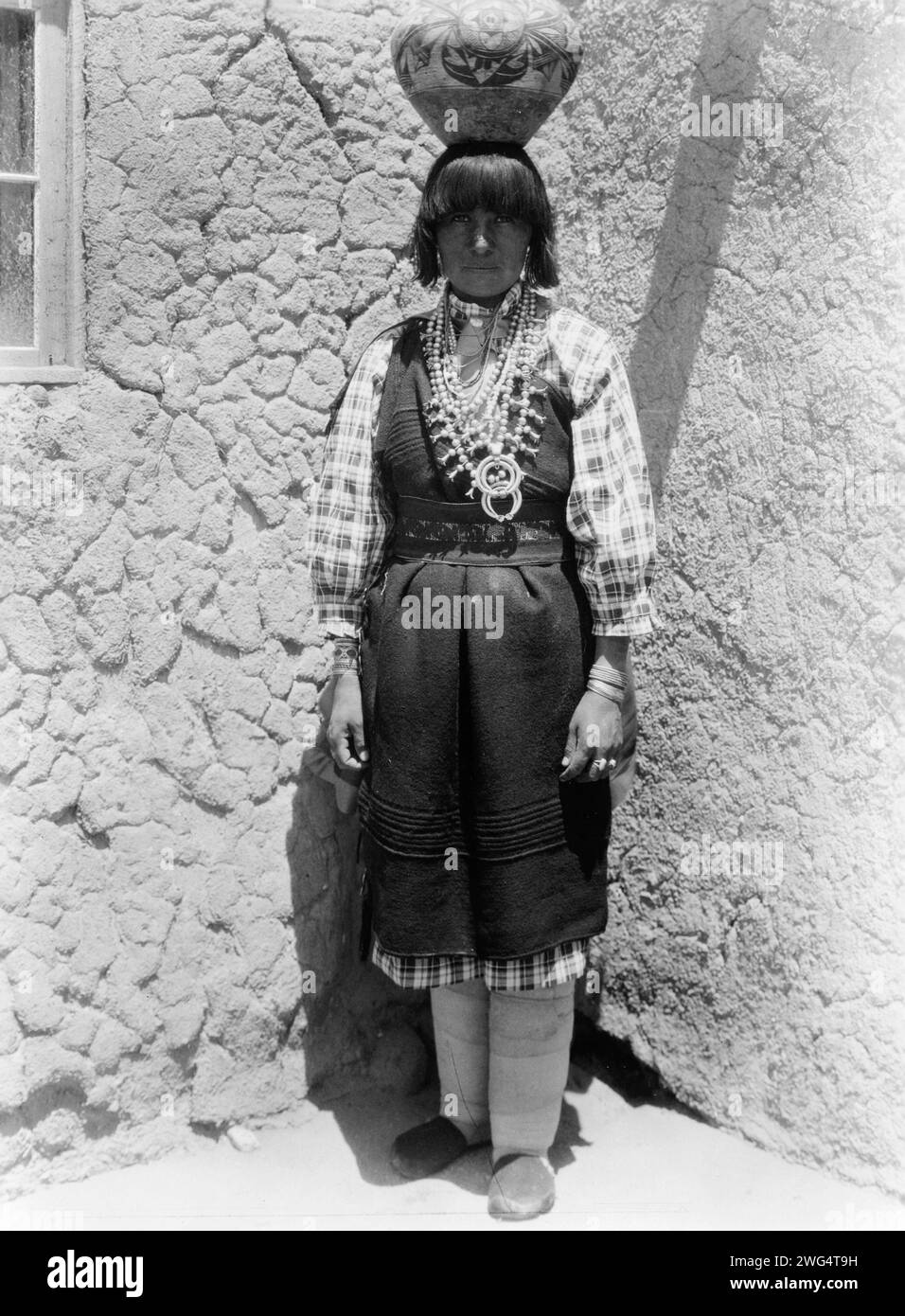 Shuati-Sia. Full-length portrait of a woman standing, facing front, with pot on head, c1926. Stock Photo