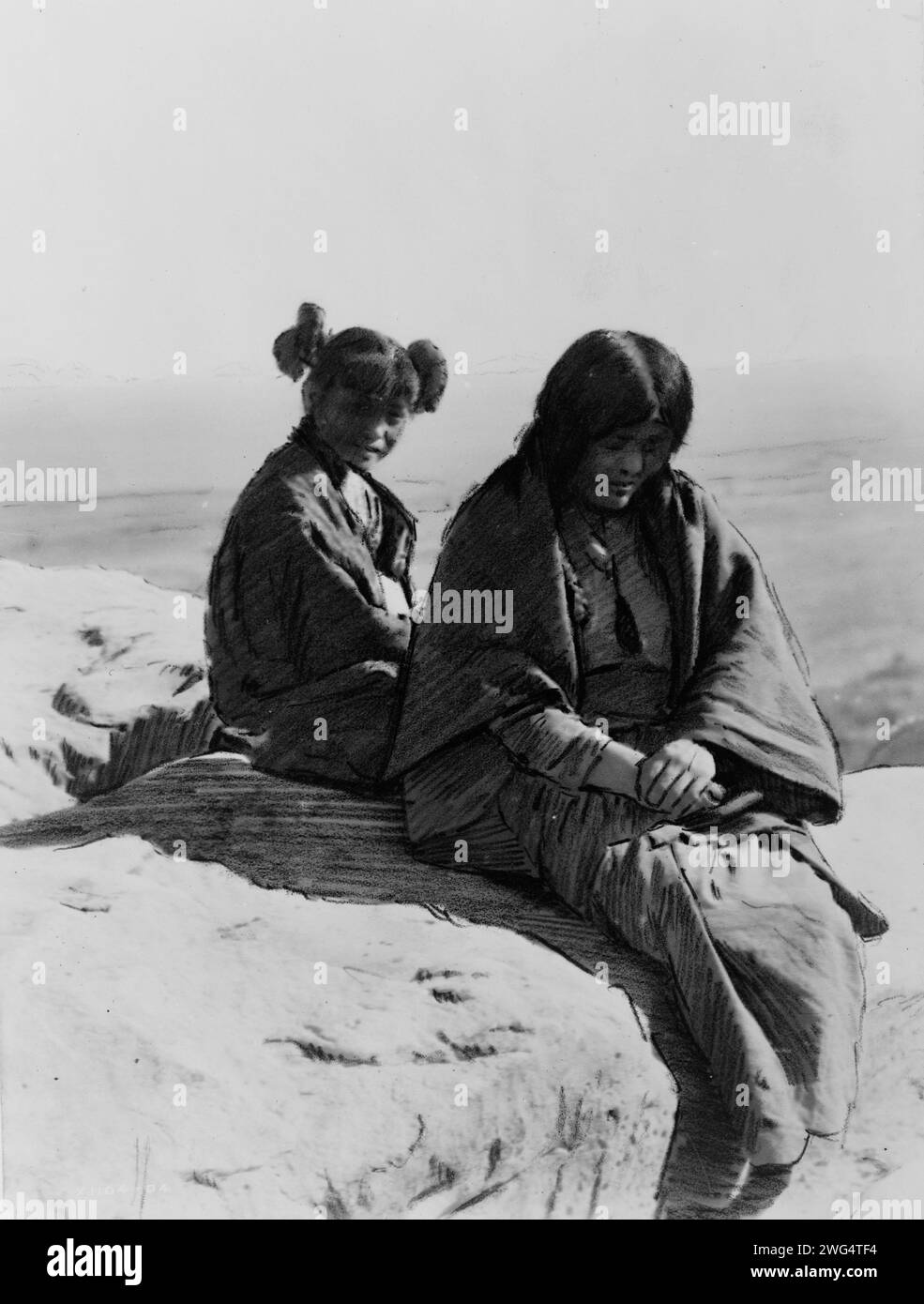 Maiden and Matron, c1905. Two Hopi females sitting on a rock. Stock Photo