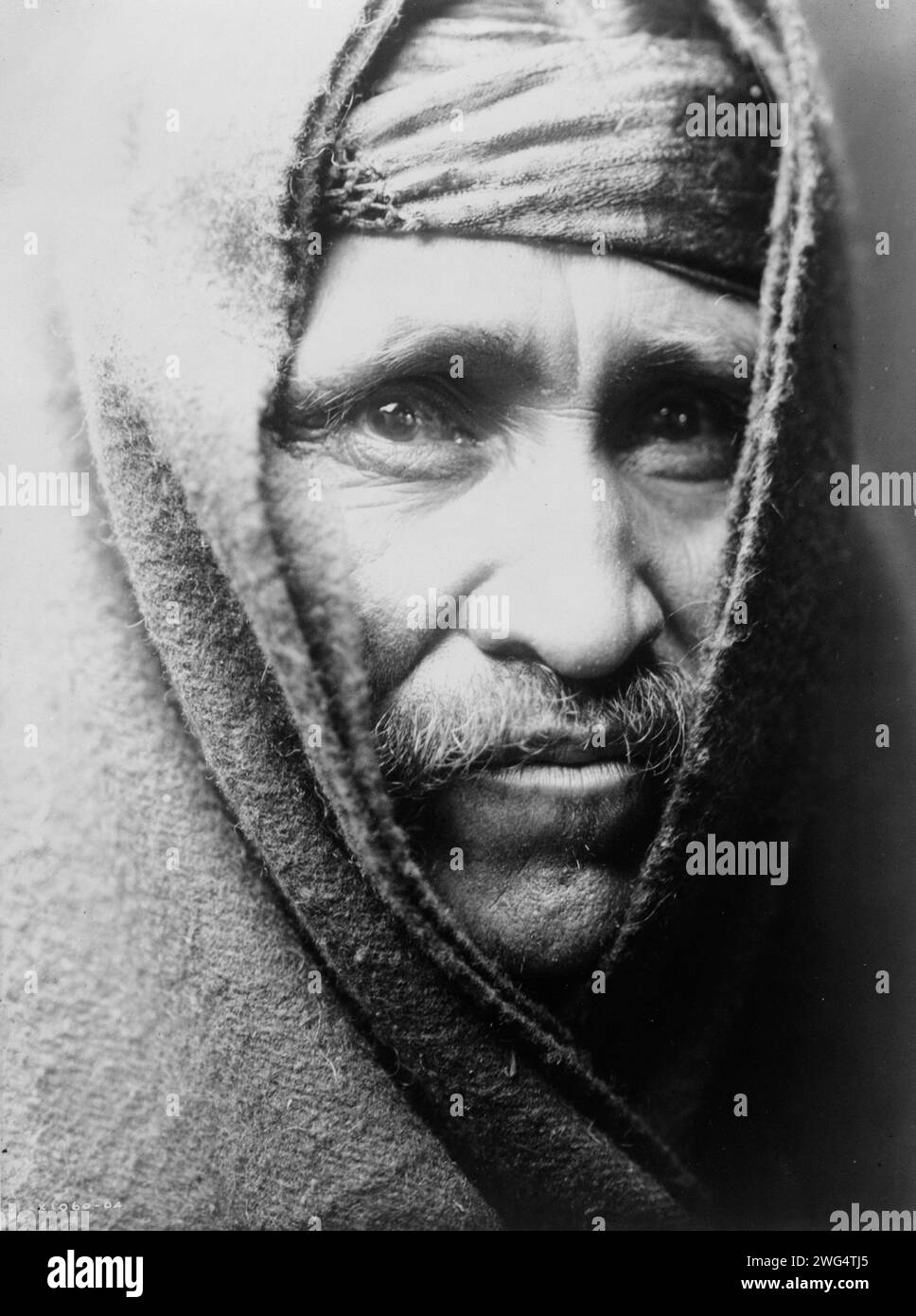 The Chanter, c1905. Head-and-shoulders portrait of Navajo Indian, wrapped in blanket. Stock Photo