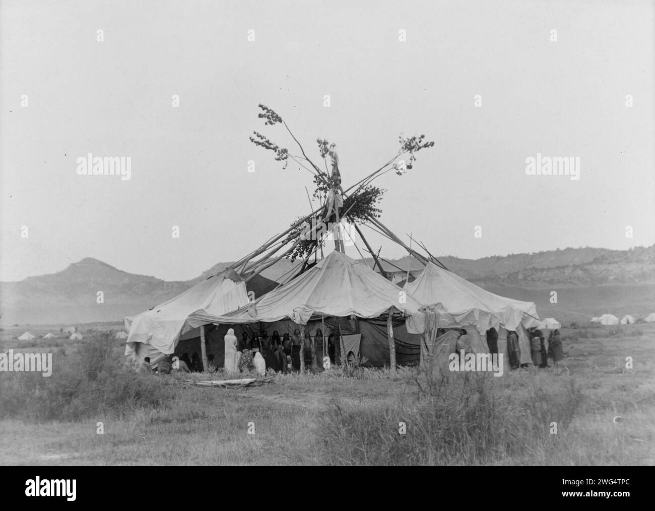 Gray Dawn-Cheyenne, c1910. Sun dance lodge with Cheyenne people standing inside. Stock Photo