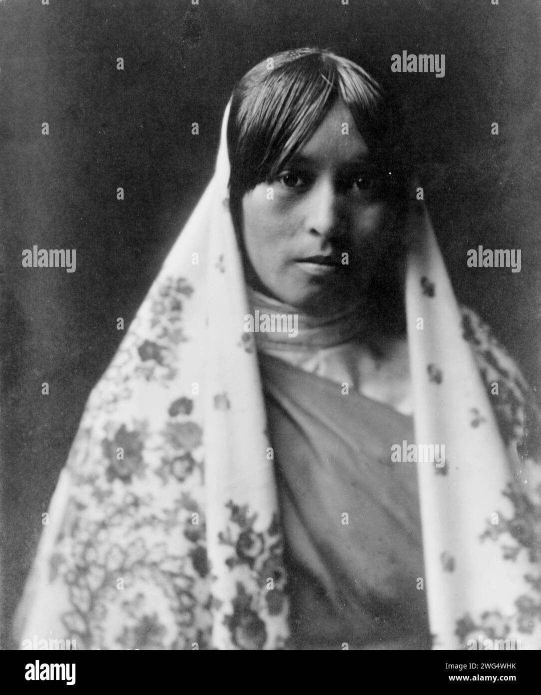 Walvia (&quot;Medicine Root&quot;)-Taos, c1905. Half-length portrait of young woman facing front wearing flowered shawl. Stock Photo