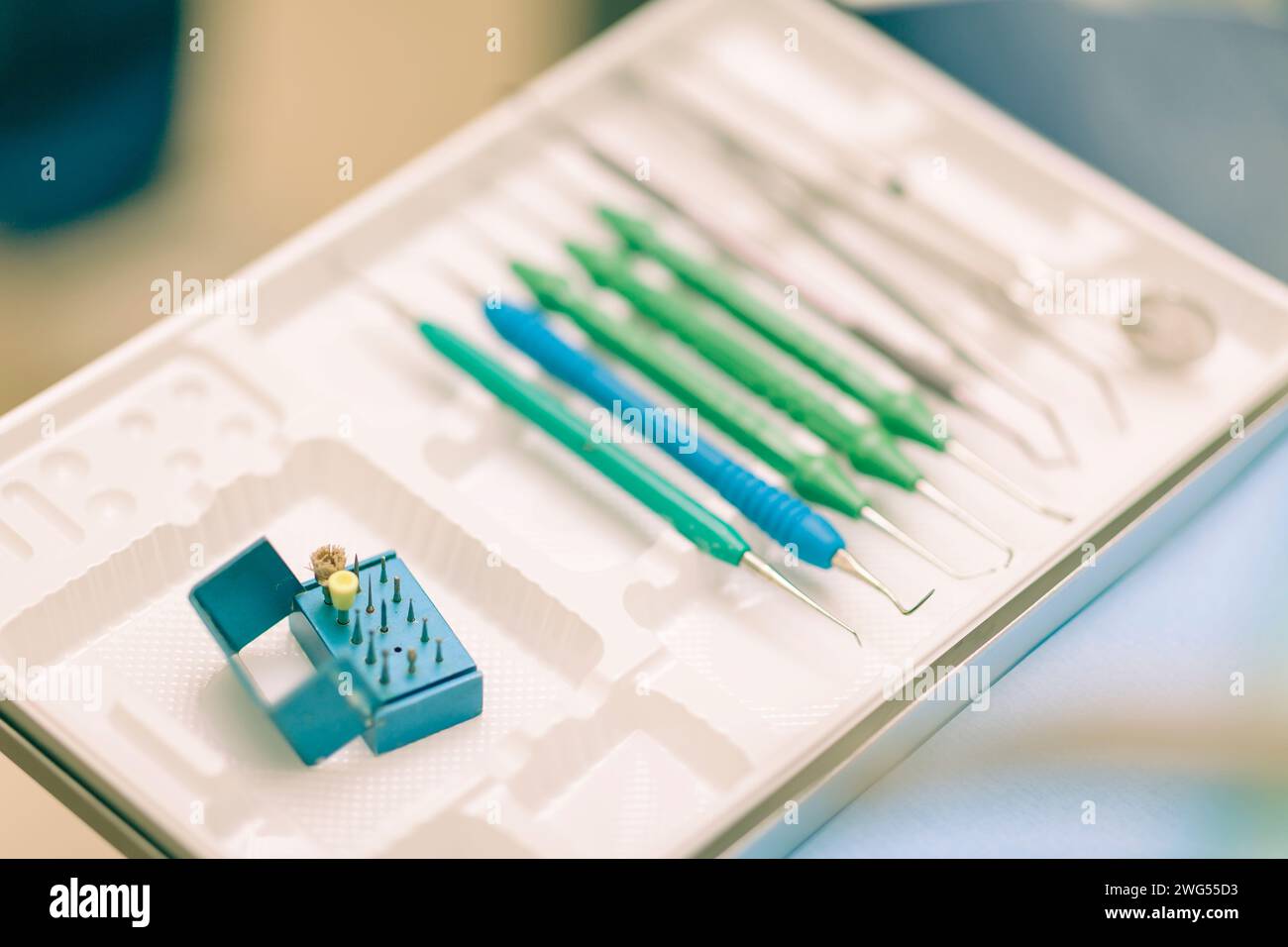 Detail of a dentist performing surgery with anesthesia on a patient for