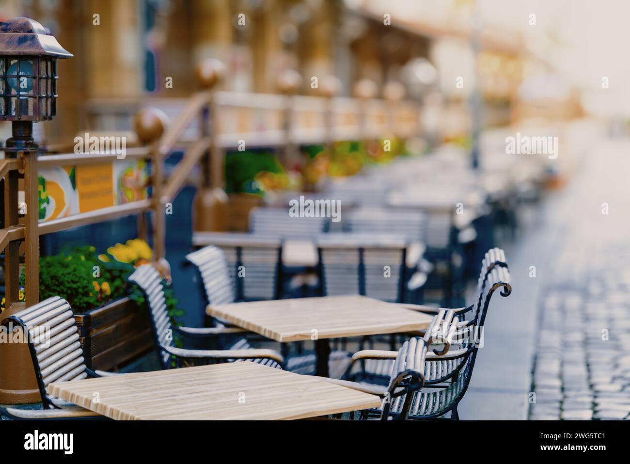 chairs and tables of a street restaurant in an empty city Stock Photo