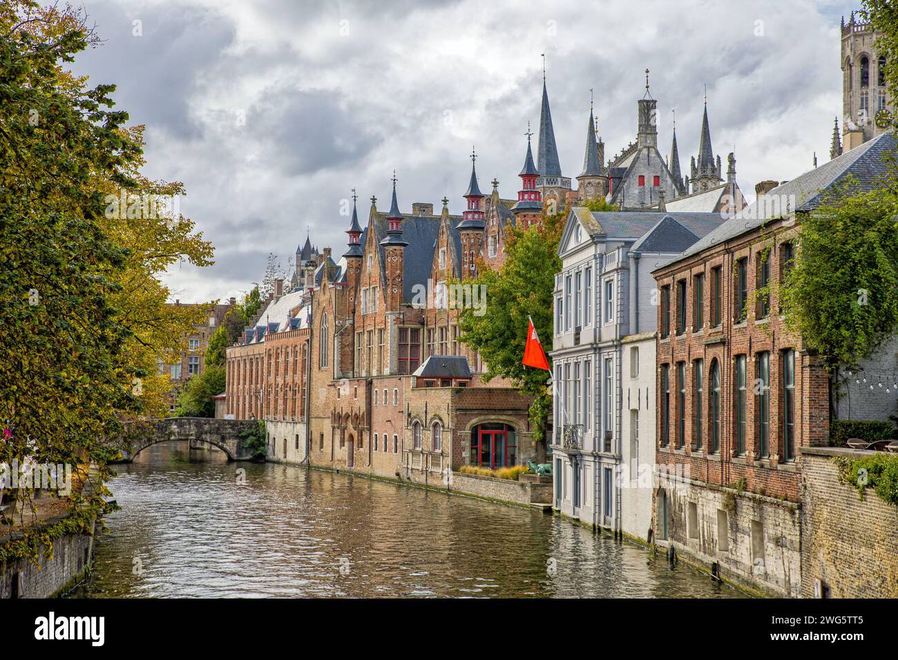 a canal in bruges with beautiful old buildings in autumn Stock Photo