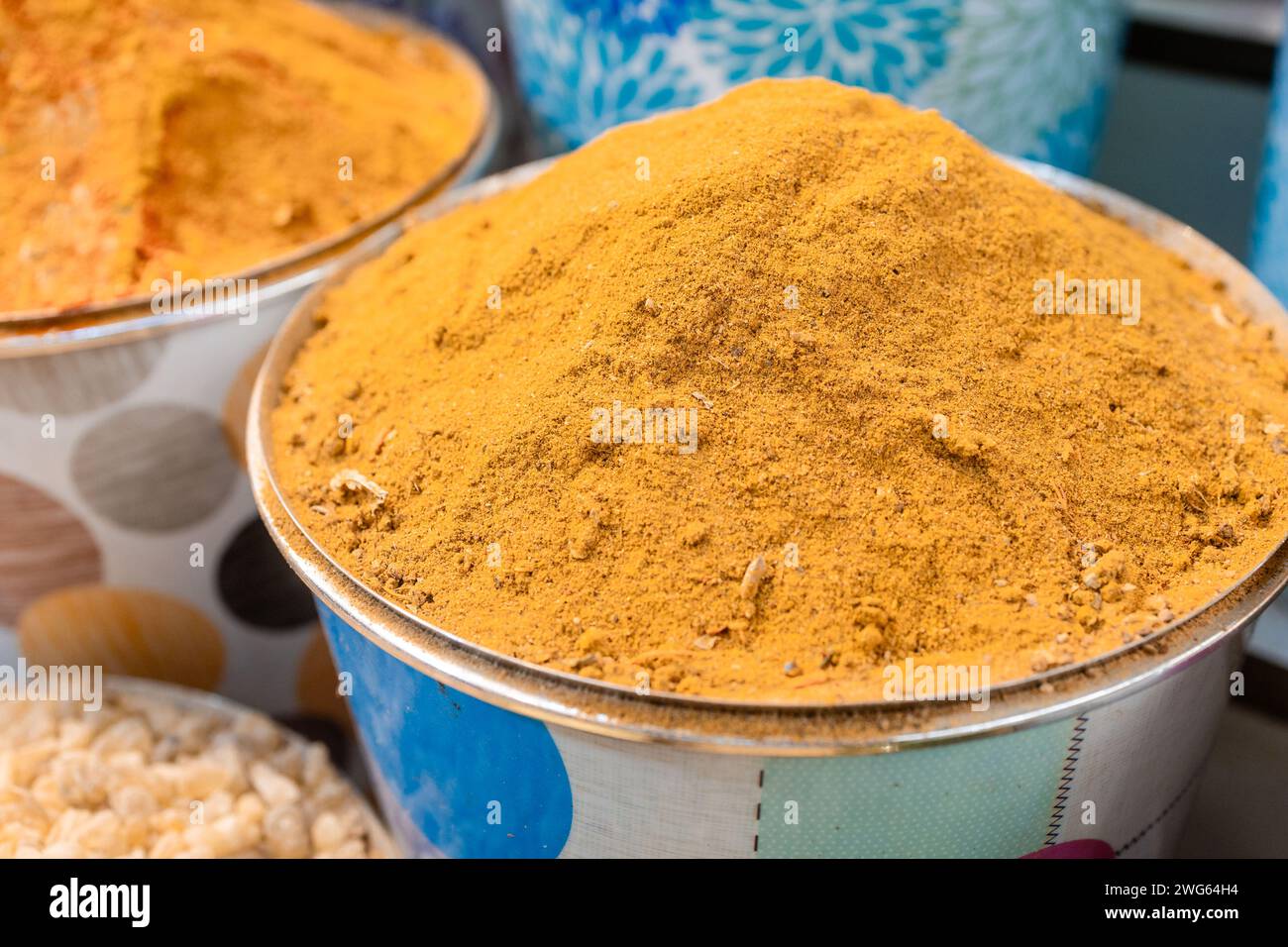 Closeup of bowl with yellow curry spice in Dubai market Stock Photo