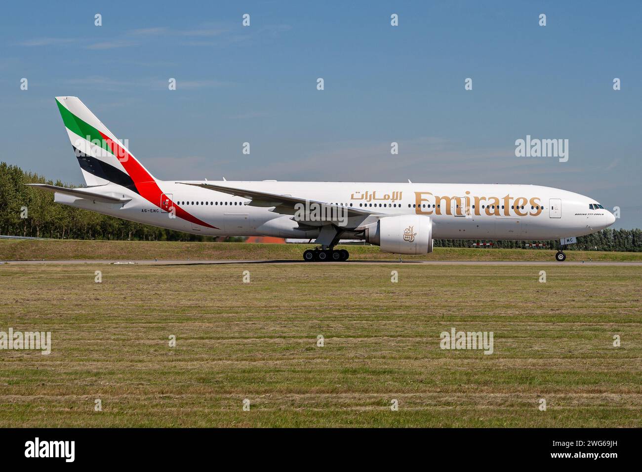 Emirates Boeing 777-200 with registration A6-EWC rolling on taxiway V of Amsterdam Airport Schiphol Stock Photo