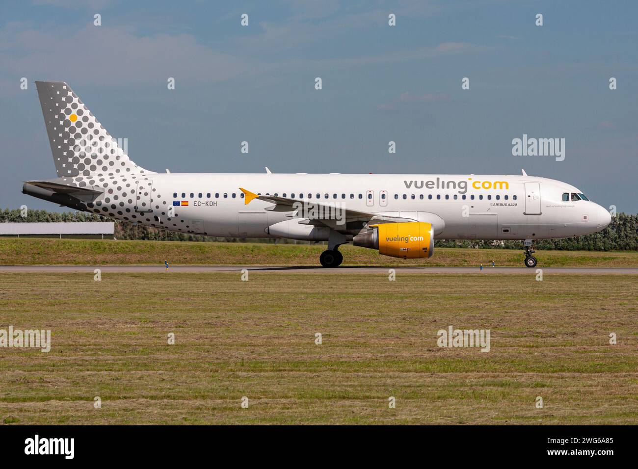 Spanish Vueling Airbus A320-200 with registration EC-KDH rolling on taxiway V of Amsterdam Airport Schiphol Stock Photo