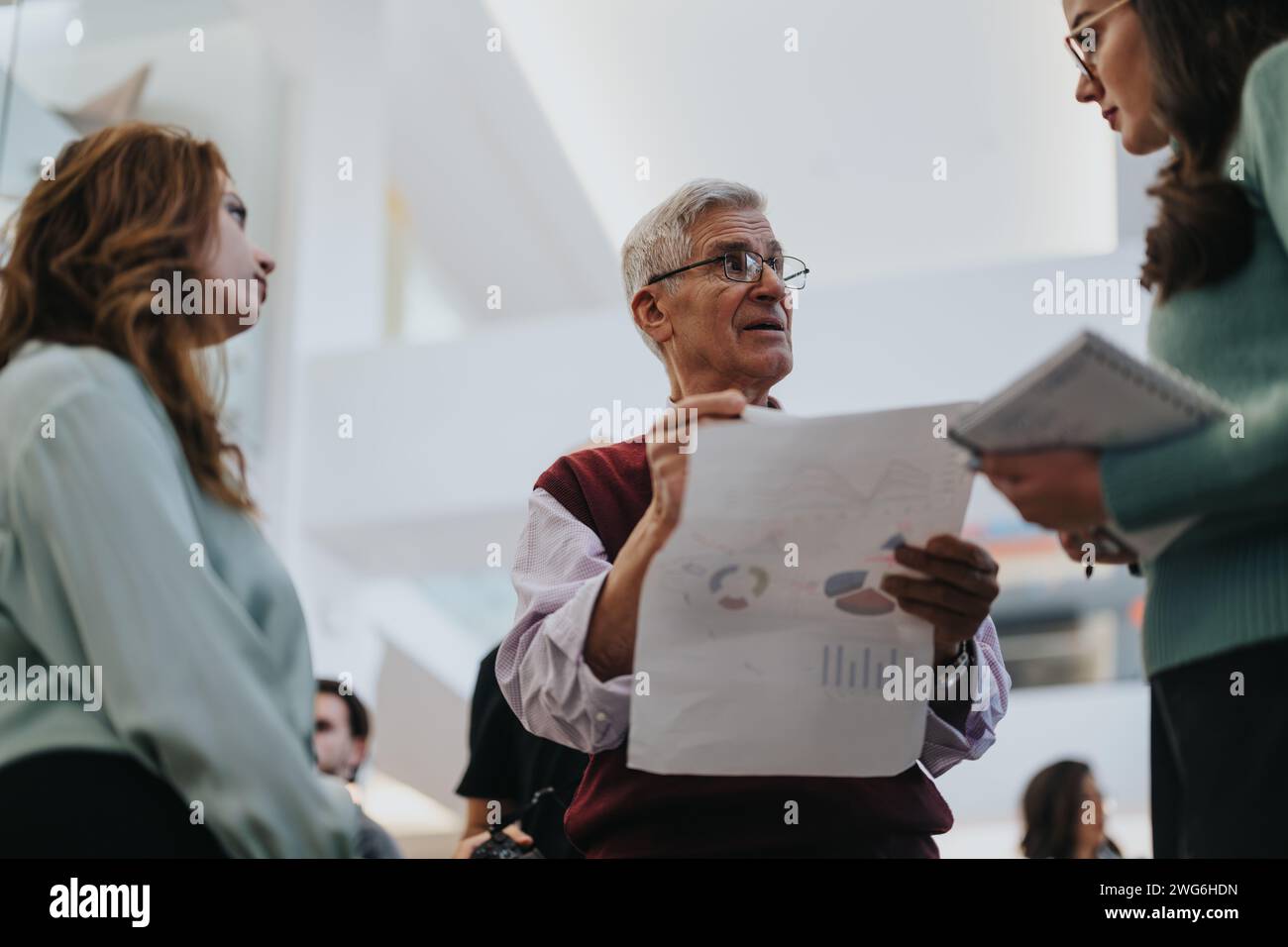 Senior Collaborative Senior businessman discussing charts during a collaborative team ...