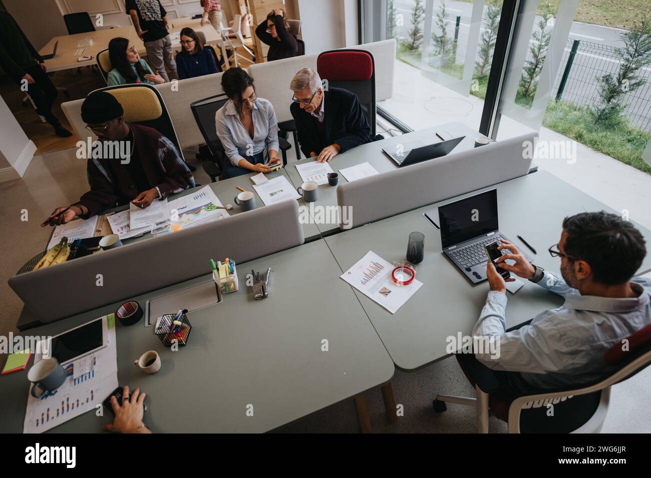 A group of diverse professionals collaborate during a business meeting ...