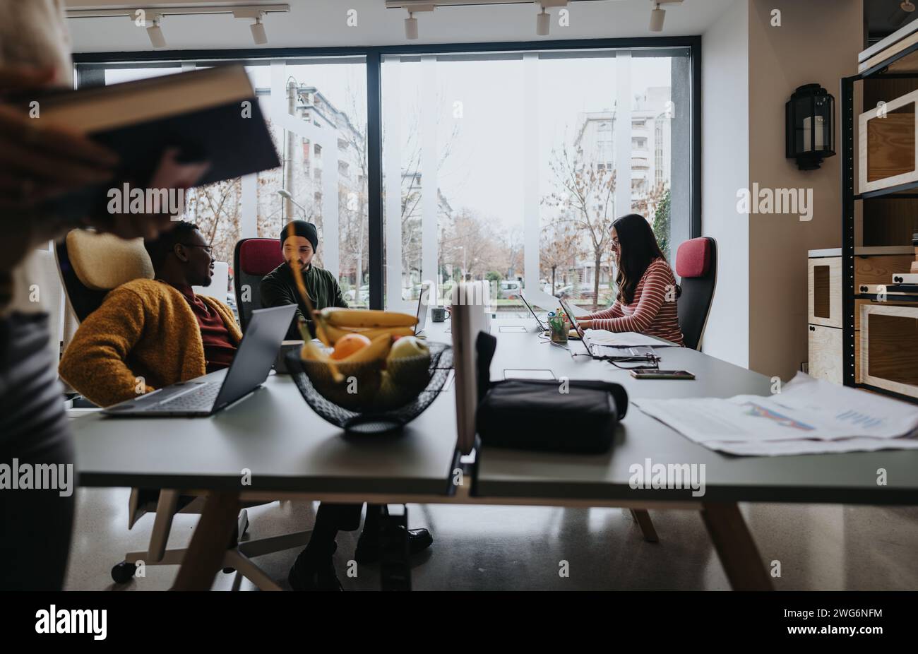 Multicultural team collaborating in a contemporary office setting with ...