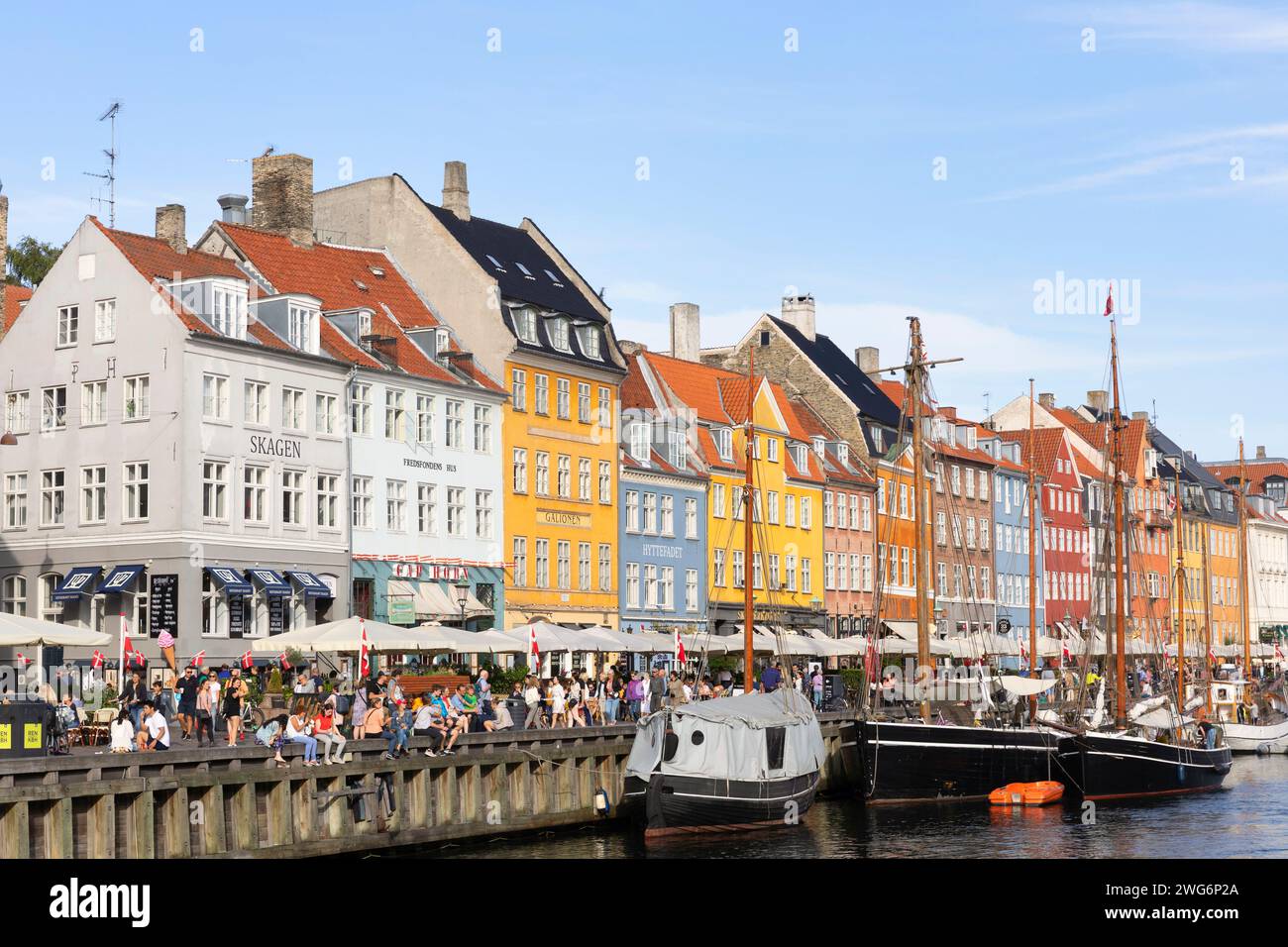 Nyhavn or New Harbour is a 17th-century harbour, canal and entertainment district in Copenhagen. Stock Photo