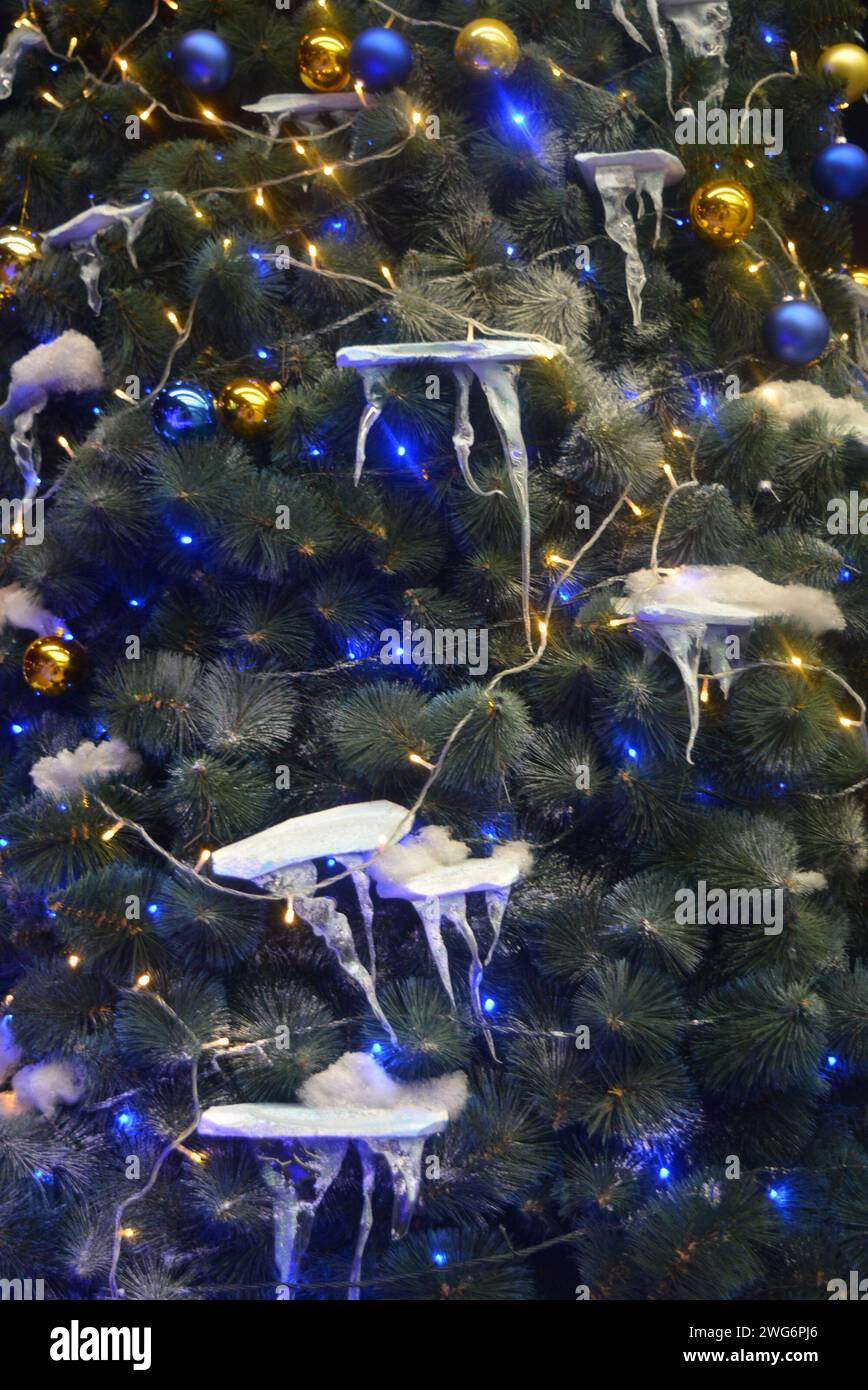 Beautiful Christmas tree decorated with gold and blue balls with snow ...