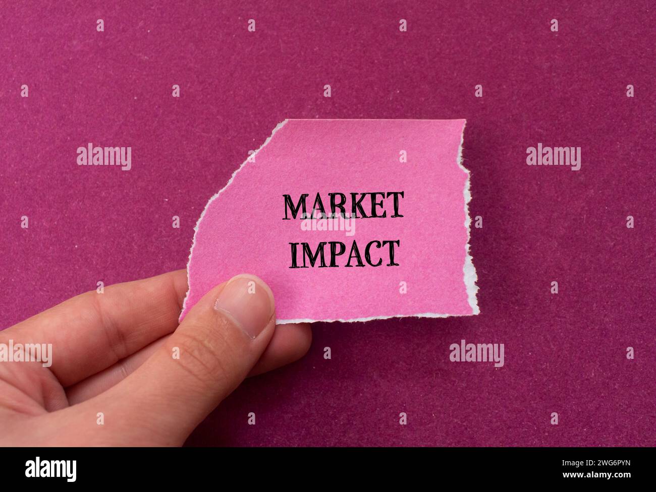 Market impact lettering on ripped paper with purple background. Conceptual business symbol. Top view, copy space. Stock Photo