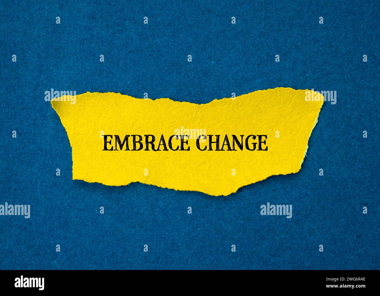 Embrace change lettering on ripped paper with blue background ...