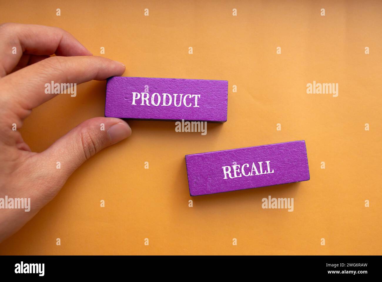 Product recall lettering on wooden blocks with orange background. Conceptual business symbol. Top view, copy space. Stock Photo