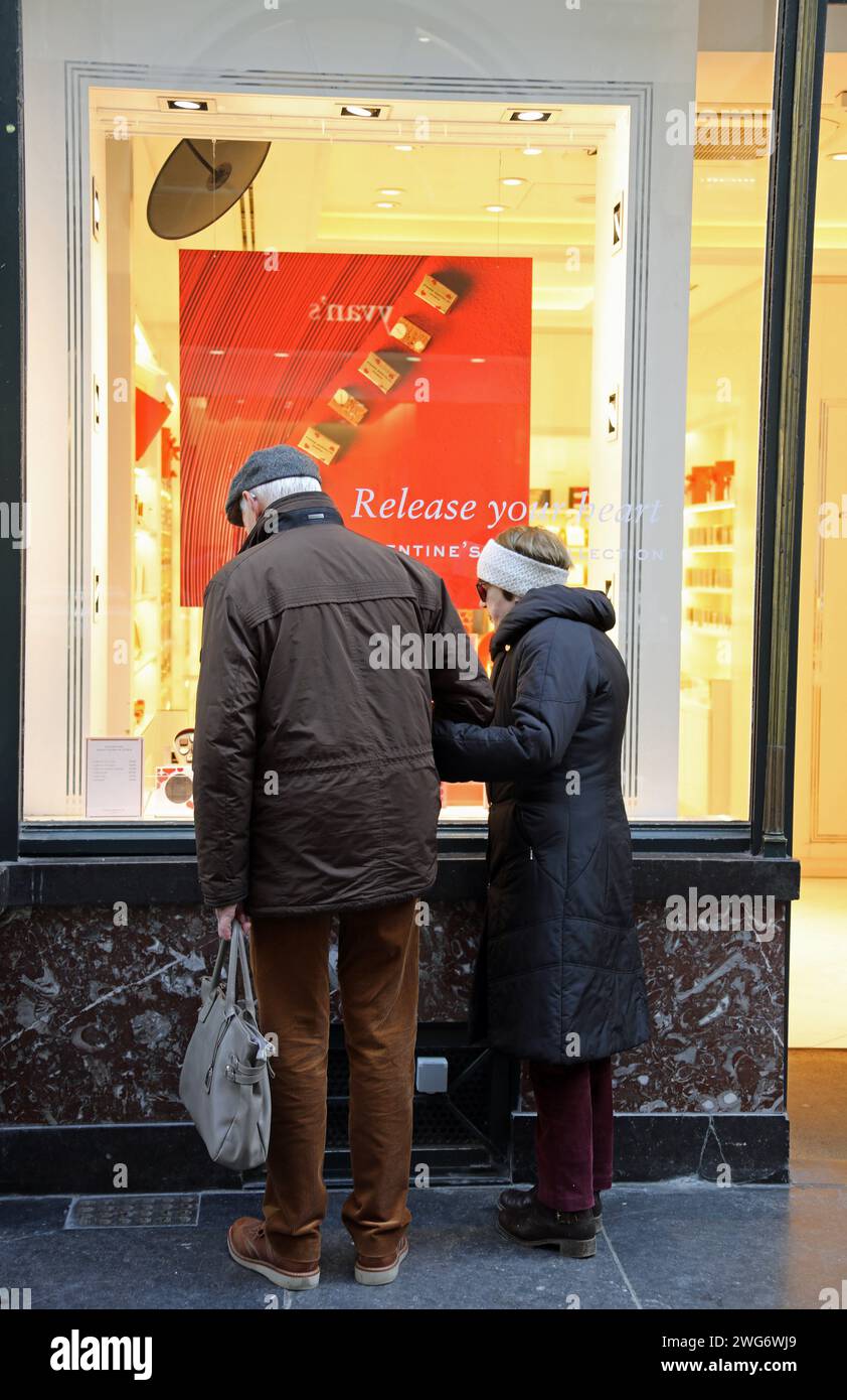 Elderly couple window shopping for Valentines Day chocolates in Brussels Stock Photo