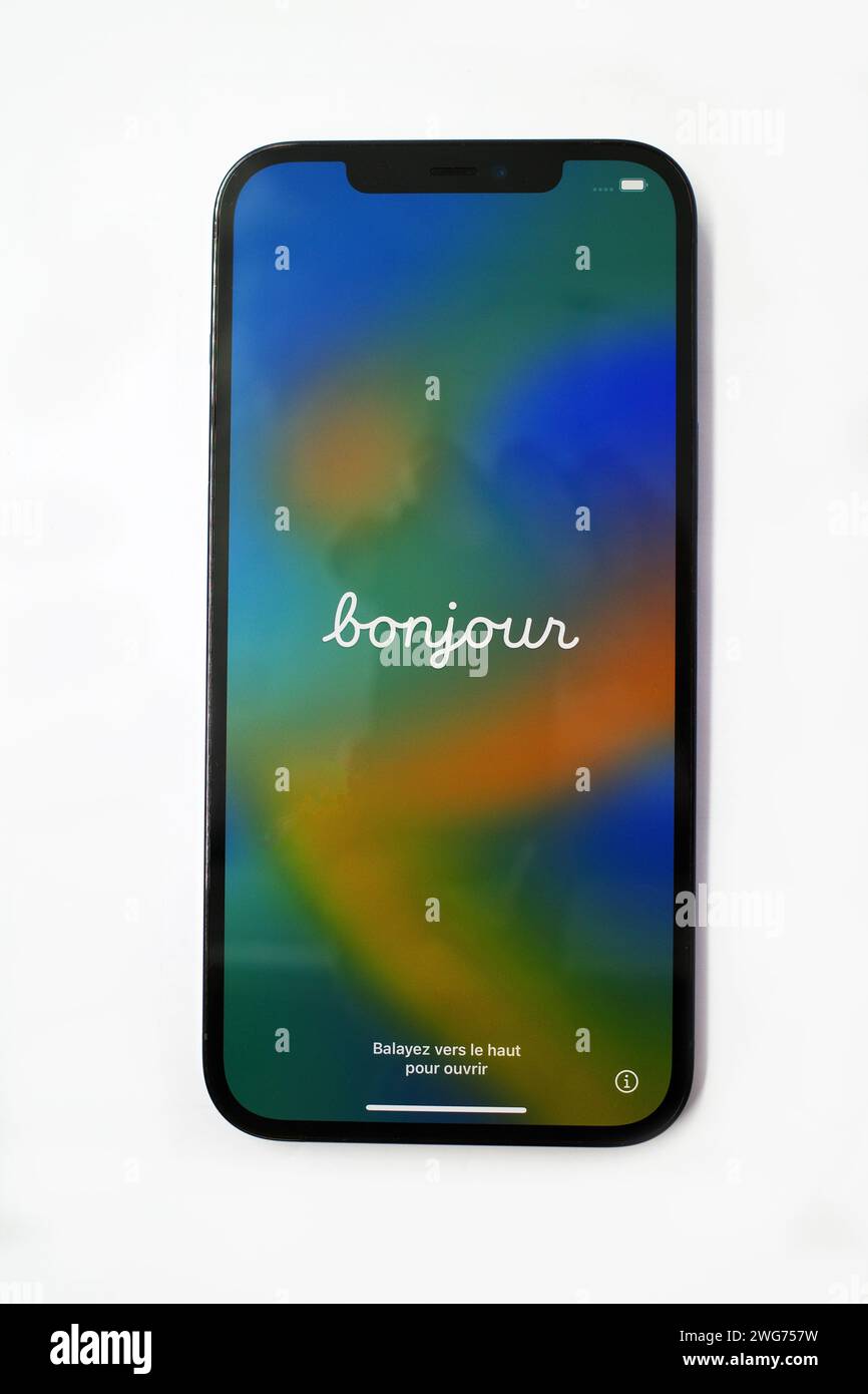 Itterbeck, Germany -Feb 2 2023 Front, screen side, of an Apple iPhone 12 Pro Max. The word Bonjour is displayed on the screen. This is French and and Stock Photo
