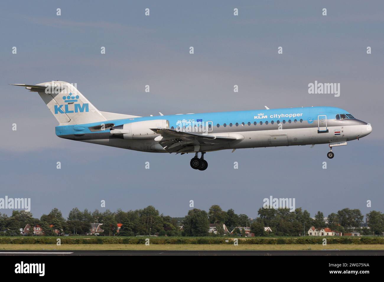 Dutch KLM Cityhopper Fokker 70 with registration PH-KZG on short final for Amsterdam Airport Schiphol Stock Photo