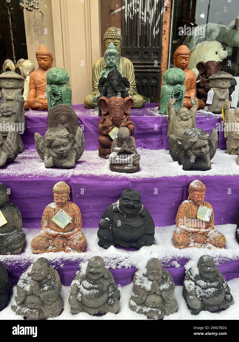 Sitting Buddhas and other figures for sale in front of  a shop in the Park Slope neighborhood of Brooklyn, New York. Stock Photo